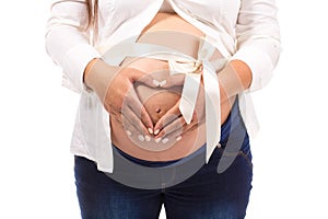 Pregnant Woman holding her hands in a heart shape