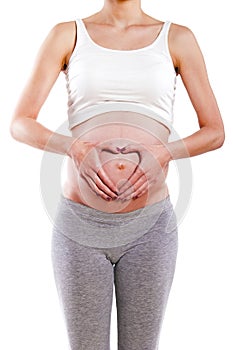 Pregnant Woman holding her hands in a heart shape on her baby