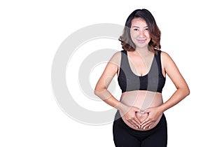 Pregnant Woman holding her hands in a heart shape on her belly i