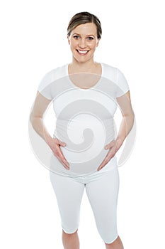 Pregnant woman holding her tummy