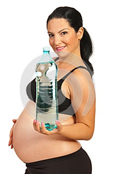 Pregnant woman holding two-liter bottle of water