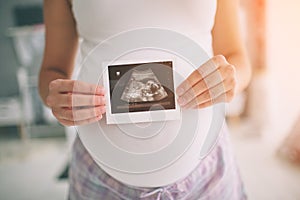 Pregnant woman holding ultrasound scan. Concept of Pregnancy health care