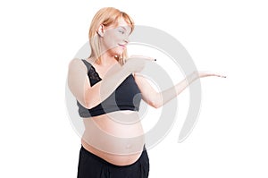 Pregnant woman holding white copy space on palm