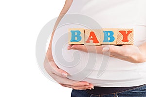Pregnant woman holding wooden blocks