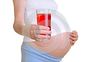 The pregnant woman holds a juice