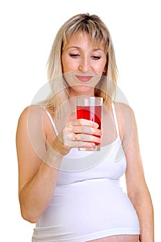 The pregnant woman holds a juice