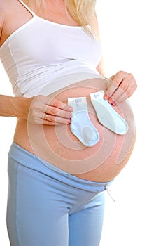 The pregnant woman holds little socks