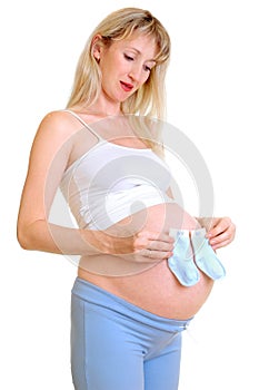 The pregnant woman holds little socks