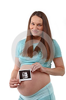 Pregnant woman holds ultrasonography baby picture