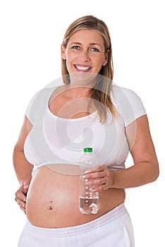 Pregnant woman holds a water bottle in her hand
