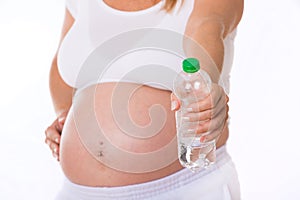 Pregnant woman holds a water bottle in her hand