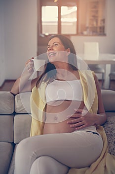 Pregnant woman at home.