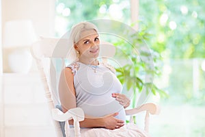 Pregnant woman at home. Young expecting mother