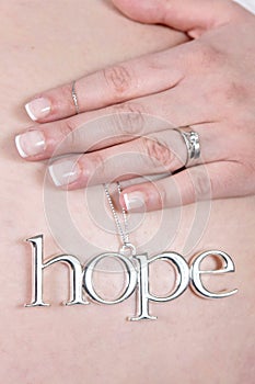 Pregnant woman with hope charm photo