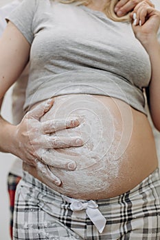 Pregnant woman husband hug hand trace flour