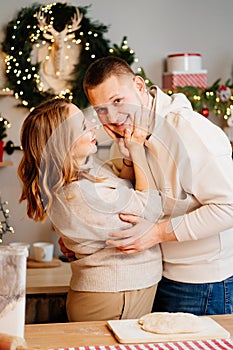 pregnant woman with husband in New Year& x27;s kitchen prepares and have fun