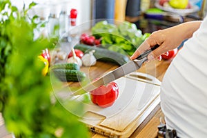 Pregnant woman with insuline pump preparing healthy food in the kitchen photo