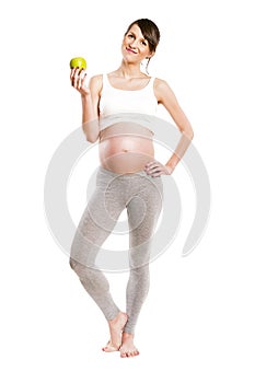 Pregnant woman isolated over white background, holding apple.