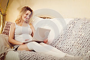 Pregnant woman with laptop