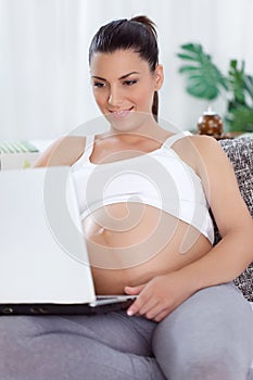 Pregnant woman with a laptop