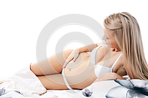 The pregnant woman lays isolated