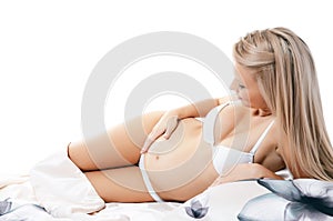 The pregnant woman lays isolated photo