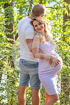 Pregnant woman leaning on man