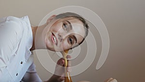 A pregnant woman lies on a couch in the clinic and a woman doctor listens to the baby`s pulse through the abdomen with