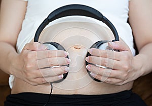 Pregnant woman listen to the music
