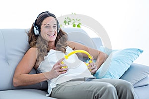 Pregnant woman listening to music in living room
