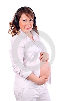 Pregnant woman listens to music on headphones