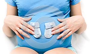 Pregnant woman with little socks