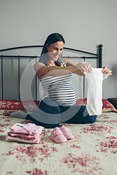 Pregnant woman looking baby girl body