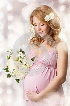 Pregnant woman looking at belly