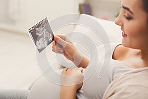 Pregnant woman looking at her baby sonography