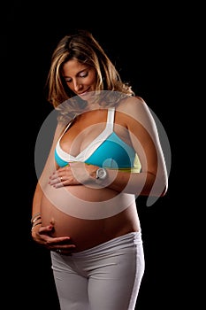 Pregnant woman looking and holding her belly