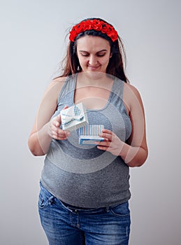 Pregnant woman looking at medicine