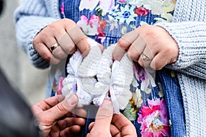 Pregnant woman and loving husband holding baby`s bootees