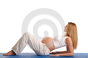 Pregnant woman lying down and practicing yoga