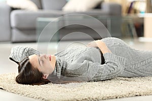 Pregnant woman lying on the floor at home