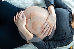 Pregnant woman lying on her back and resting