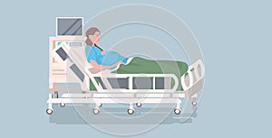 pregnant woman lying in hospital bed before childbirth maternity pregnancy concept full length