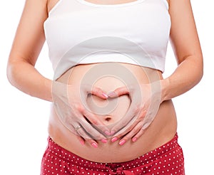 Pregnant woman making heart shape with her hands