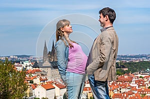 Pregnant woman and a man compare their bellies