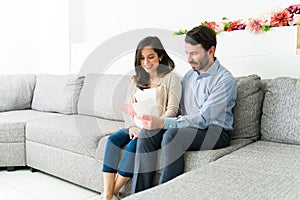 Pregnant woman and man reading a medical brochure