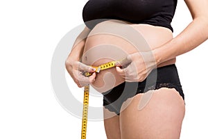 Pregnant woman measuring her abdomen