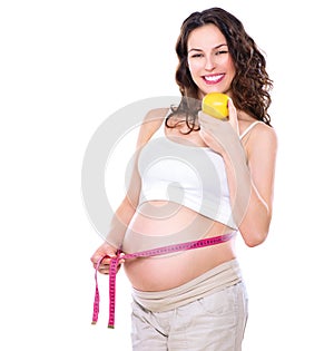 Pregnant woman measuring her big belly