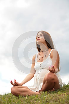 Pregnant woman is meditating
