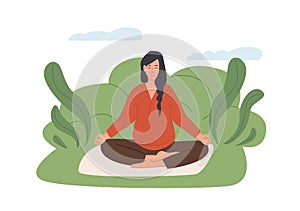 Pregnant woman meditating outdoors. Prenatal yoga. Woman in park sitting with legs crossed and practicing meditation