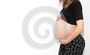 Pregnant woman model touching her pregnancy belly abdomen, isolated on white background